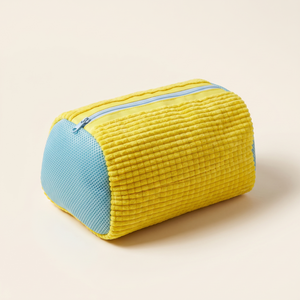 Yellow sneaker wash bag on a clean studio background